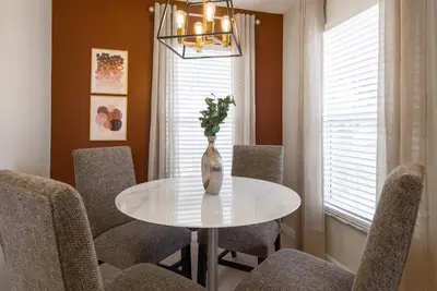 a dining room with a white table and chairs at Great 6bedrooms home in Kissimmee w Private Pool 8426 in Kissimmee