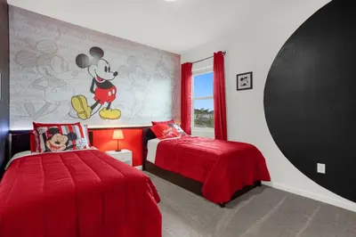 a bedroom with two beds and a mickey mouse mural at Super Deal - Brand New Themed 9BR Home near Disney in Kissimmee