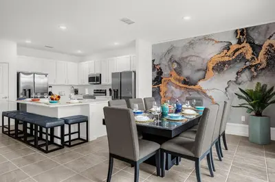 a kitchen and dining room with a table and chairs at Super Deal - Brand New Themed 9BR Home near Disney in Kissimmee