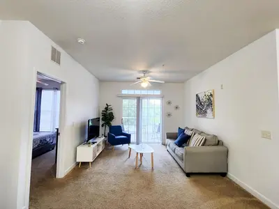 a living room with a couch and a table at Retreat at Secret Lake 10 mins to Disney in Kissimmee