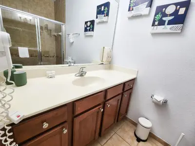 a bathroom with a sink and a mirror at Retreat at Secret Lake 10 mins to Disney in Kissimmee
