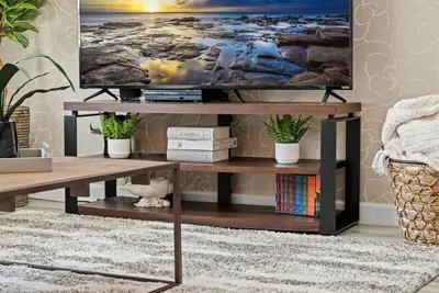 a living room with a tv on a wooden table at Family Fun with Mickey and Frozen at Storey Lake in Kissimmee