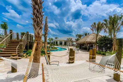 a resort with a hammock and a swimming pool at Family Fun with Mickey and Frozen at Storey Lake in Kissimmee