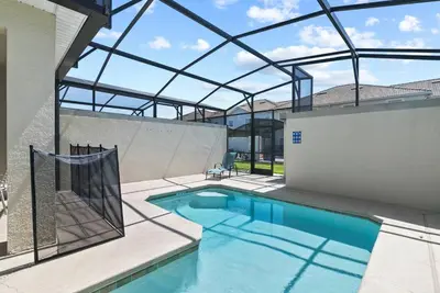 a swimming pool with a glass roof over it at Family Fun with Mickey and Frozen at Storey Lake in Kissimmee
