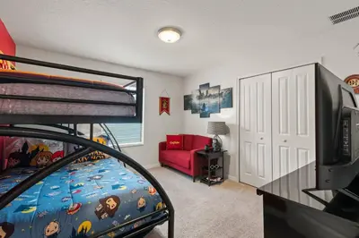 a bedroom with a bunk bed and a living room at Storey Lake Townhome fun for families at Remy's Retreat in Kissimmee
