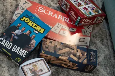 a pile of books and a board game and a game at Storey Lake Townhome fun for families at Remy's Retreat in Kissimmee