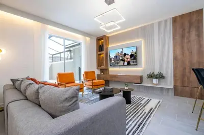 a living room with a couch and a tv at WonderFul 4Bd w Pool Close to Disney at StoreyLake 2669 in Kissimmee