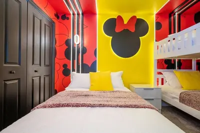 a bedroom with a bed and a yellow and red wall at WonderFul 4Bd w Pool Close to Disney at StoreyLake 2669 in Kissimmee