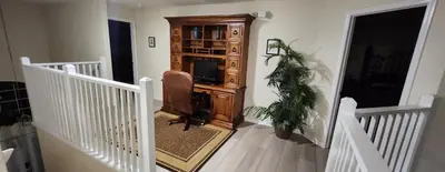 a living room with a tv in a wooden cabinet at Emerald Island Diamond on the Island in Kissimmee