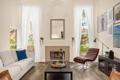 a living room with a white couch and a fireplace at Luxury 4BR Home at Ventura Golf and Country Club in Orlando