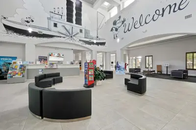 a lobby with chairs and a welcome sign in a store at 5 Minutes to Disney Free Shuttle King & queen bed in Orlando