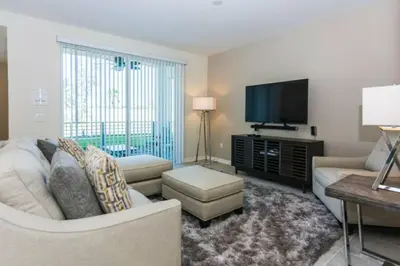 a living room with a couch and a flat screen tv at Premium Apartment 2BR2BA • Near Disney • PoolLazy River at Storey Lake Resort SL47316 in Kissimmee