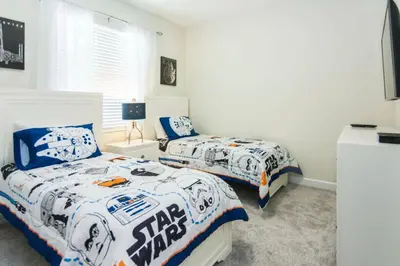 a bedroom with two beds with football themed sheets at Delux Apartment 4BR3BA • Near Disney • PoolLazy River at Storey Lake Resort SL47412 in Kissimmee