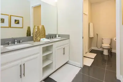 a bathroom with two sinks and a toilet at Delux Apartment 4BR3BA • Near Disney • PoolLazy River at Storey Lake Resort SL47412 in Kissimmee