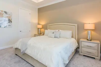 a bedroom with a white bed and two night stands at Delux Apartment 4BR3BA • Near Disney • PoolLazy River at Storey Lake Resort SL47412 in Kissimmee