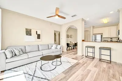 a living room with a couch and a table at 3BR Condo - Near Disney Balcony Pool in Orlando