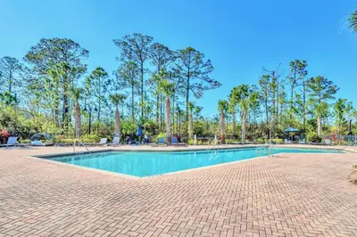 a swimming pool in a park with palm trees at 3BR Condo - Near Disney Balcony Pool in Orlando