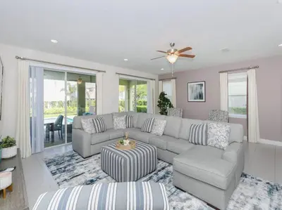 a living room with a couch and a table at Luxurious Villa 9br Encore Resort near to Disney in Orlando