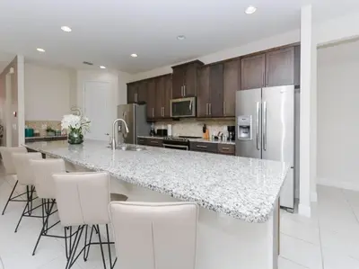 a kitchen with a large counter with white appliances at Luxurious Villa 9br Encore Resort near to Disney in Orlando