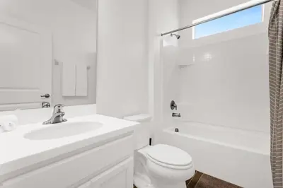 a white bathroom with a sink and a toilet at Upstay Ultimate Orlando Retreat w Pool & Hot Tub Sleeps 16 in Kissimmee