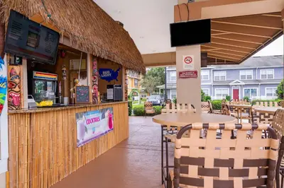 a restaurant with a bar with a table and chairs at Enchanted Townhome near Disney Parks 3Br in Kissimmee