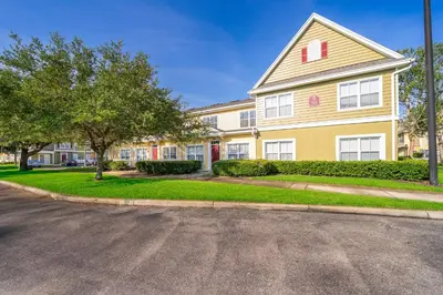 a large house with a street in front of it at Enchanted Townhome near Disney Parks 3Br in Kissimmee