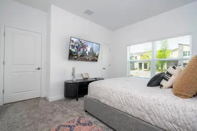 a white bedroom with a bed and a window at Gorgeous 4 Bd w Pool at Storey Lake Resort 2485 in Kissimmee