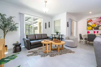 a living room with a couch and a table at Gorgeous 4 Bd w Pool at Storey Lake Resort 2485 in Kissimmee