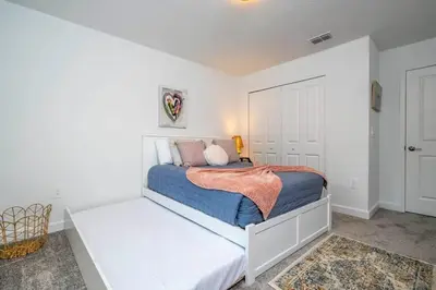 a white bedroom with a bed in a room at Gorgeous 4 Bd w Pool at Storey Lake Resort 2485 in Kissimmee