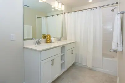 a white bathroom with a sink and a shower at Spacious Apartment 2BR2BA • Near Disney • PoolLazy River at Storey Lake Resort SL47317 in Kissimmee