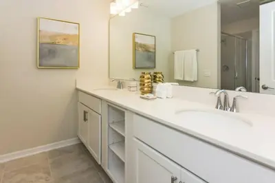 a bathroom with two sinks and a large mirror at Spacious Apartment 2BR2BA • Near Disney • PoolLazy River at Storey Lake Resort SL47317 in Kissimmee