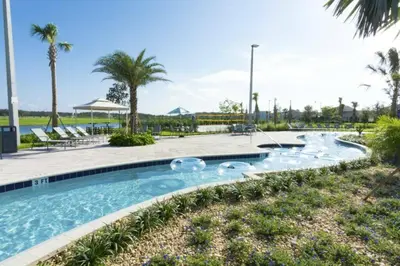 a swimming pool at a resort with palm trees at Spacious Apartment 2BR2BA • Near Disney • PoolLazy River at Storey Lake Resort SL47317 in Kissimmee