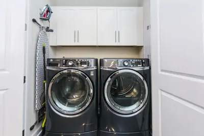 a washer and dryer in a small laundry room at Exceptional Apartment 4BR3BA • Near Disney • PoolLazy River at Storey Lake Resort SL47512 in Kissimmee