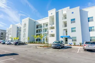 a parking lot with cars parked in front of a building at Exceptional Apartment 4BR3BA • Near Disney • PoolLazy River at Storey Lake Resort SL47512 in Kissimmee