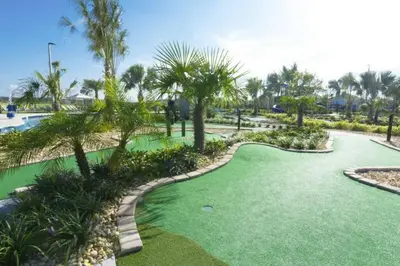 a golf course with palm trees and a putting green at Exceptional Apartment 4BR3BA • Near Disney • PoolLazy River at Storey Lake Resort SL47512 in Kissimmee