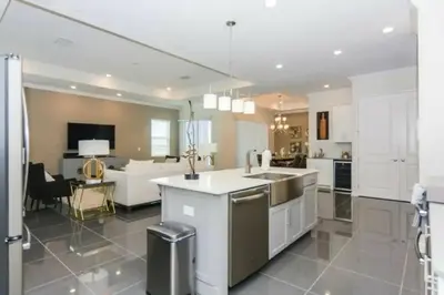 a kitchen with white cabinets and a living room at Splendid Apartment 4BR3BA • Near Disney • PoolLazy River at Storey Lake Resort SL47512 in Kissimmee