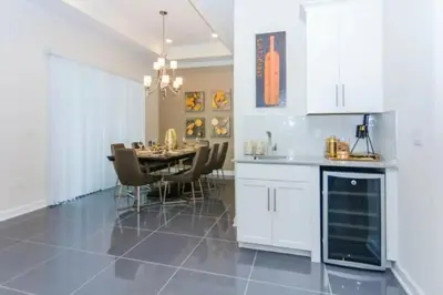 a kitchen and dining room with a table and chairs at Splendid Apartment 4BR3BA • Near Disney • PoolLazy River at Storey Lake Resort SL47512 in Kissimmee