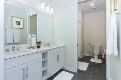 a white bathroom with a sink and a toilet at Splendid Apartment 4BR3BA • Near Disney • PoolLazy River at Storey Lake Resort SL47512 in Kissimmee