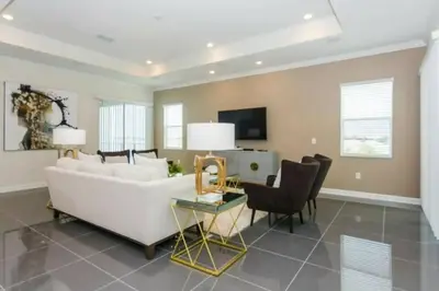 a living room with a white couch and chairs at Splendid Apartment 4BR3BA • Near Disney • PoolLazy River at Storey Lake Resort SL47512 in Kissimmee