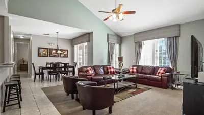 a living room with a couch and a table at Tranquil Formosa Gardens Villa in Orlando
