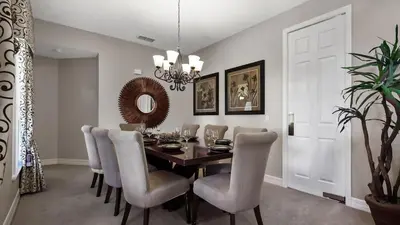 a dining room with a table and chairs at Tranquil Formosa Gardens Villa in Orlando