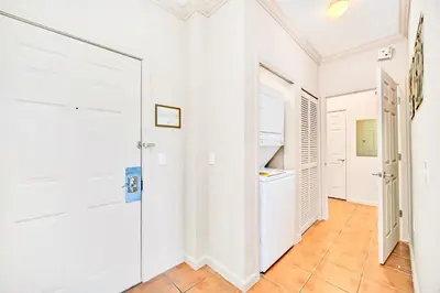 a room with white walls and a hallway with white doors at Near Disney - 2BR Condo - Balcony Pool in Orlando
