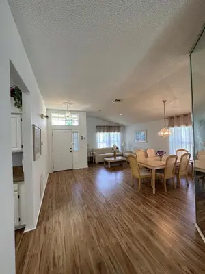 a large living room with a table and chairs at Private pool with a beautiful view overlooking the lake! Near Disney - Universal in Kissimmee