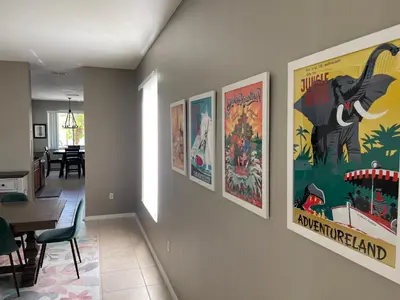 a hallway with posters on the walls of a restaurant at Its A Dream Family Vacation Rental - Minutes from Disney in Kissimmee