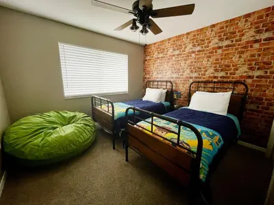 a bedroom with two bunk beds and a brick wall at Its A Dream Family Vacation Rental - Minutes from Disney in Kissimmee