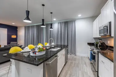 a kitchen with a sink and a counter top at Comfy Modern House w Pool Perfect Location in Orlando