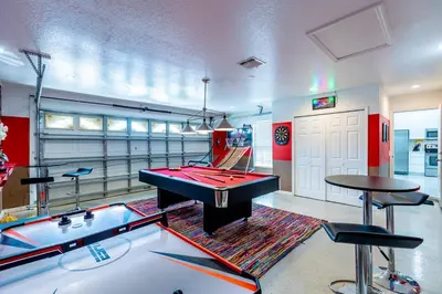 a room with a pool table and ping pong tables at 4br House w Perfect Location Pool and Much More in Kissimmee