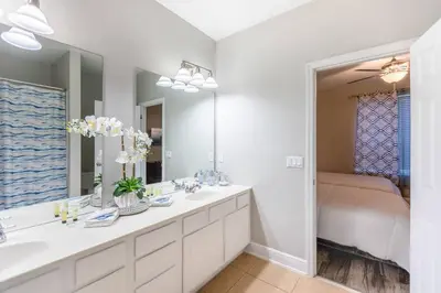 a bathroom with two sinks and a large mirror at 3BR Townhouse w Perfect Location in Orlando