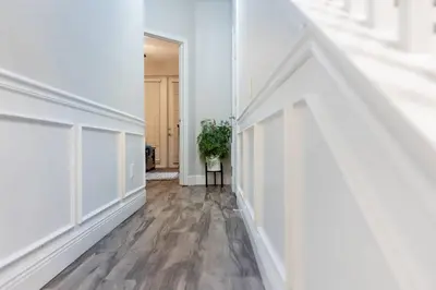 an empty hallway with white walls and wood floors at 3BR Townhouse w Perfect Location in Orlando