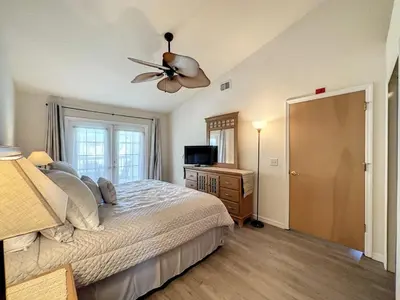a bedroom with a bed and a ceiling fan at Lovely 3 bed Condo Near Disney Quiet Community condo in Kissimmee